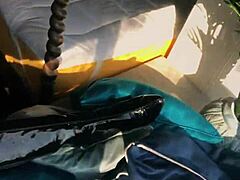 woman in shiny wetlook suit struts in glossy patent leather boots teasing ass