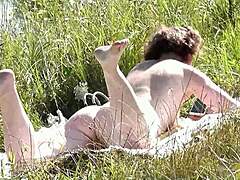 Naked in public mature milf sunbathes on wild beach without panties