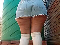 big natural booty in denim shorts and boots