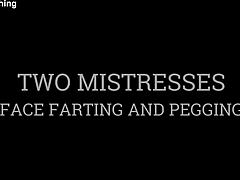 Two mistresses face farting and huge strapon pegging of bound blindfolded slave
