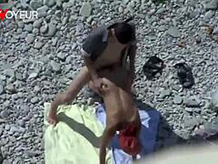 Voyeur en la playa pilla a milf curvilínea mamando y follando a lo perrito en público con marcas de bronceado